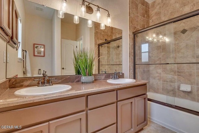 6365 Franklin Trail Dr, El Paso, TX 79912 - full bathroom featuring double vanity, shower / bath combination with glass door, and tile patterned floors