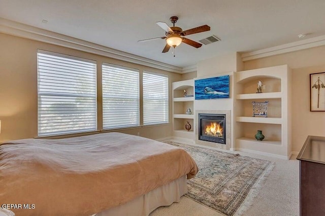 6365 Franklin Trail Dr, El Paso, TX 79912 - carpeted bedroom featuring a fireplace, a ceiling fan, and ornamental molding