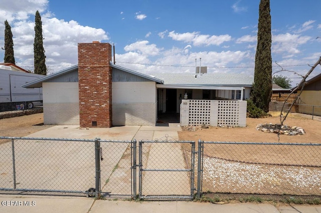 5033 Royal Dr, El Paso, TX 79924 - single story home with a gate, brick siding, and a chimney