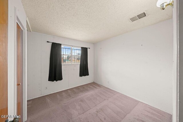 5033 Royal Dr, El Paso, TX 79924 - carpeted empty room with a textured ceiling