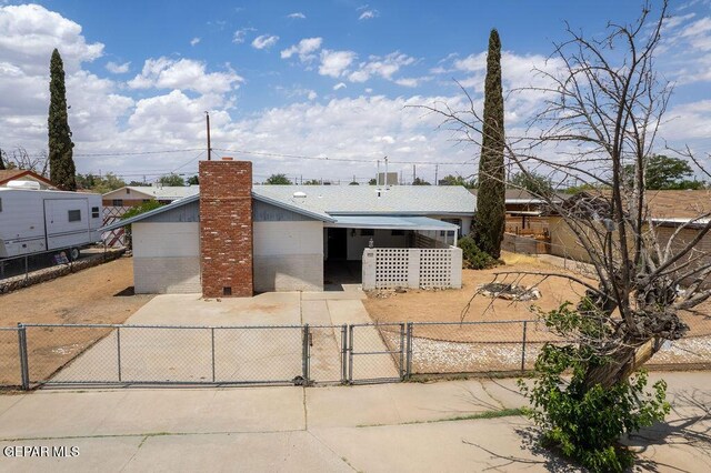 5033 Royal Dr, El Paso, TX 79924 - view of front of house featuring a gate, a chimney, brick siding, and a garage