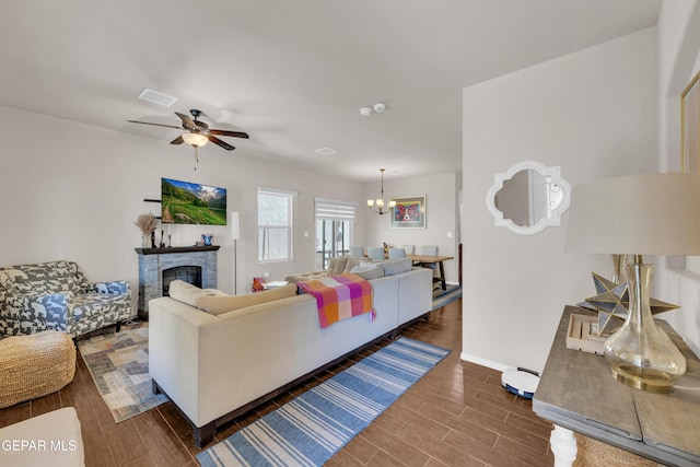 6716 Red Canyon Sage Ln, El Paso, TX 79912 - living area featuring wood finished floors, a chandelier, ceiling fan, baseboards, and a fireplace