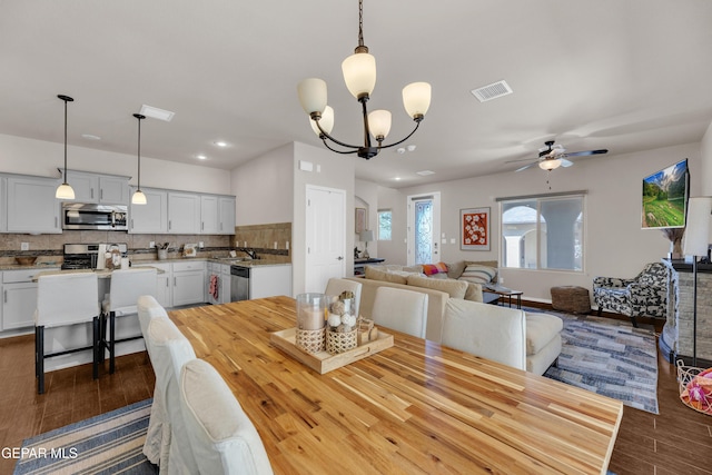 6716 Red Canyon Sage Ln, El Paso, TX 79912 - dining space with dark wood-style flooring, ceiling fan, a chandelier, and recessed lighting