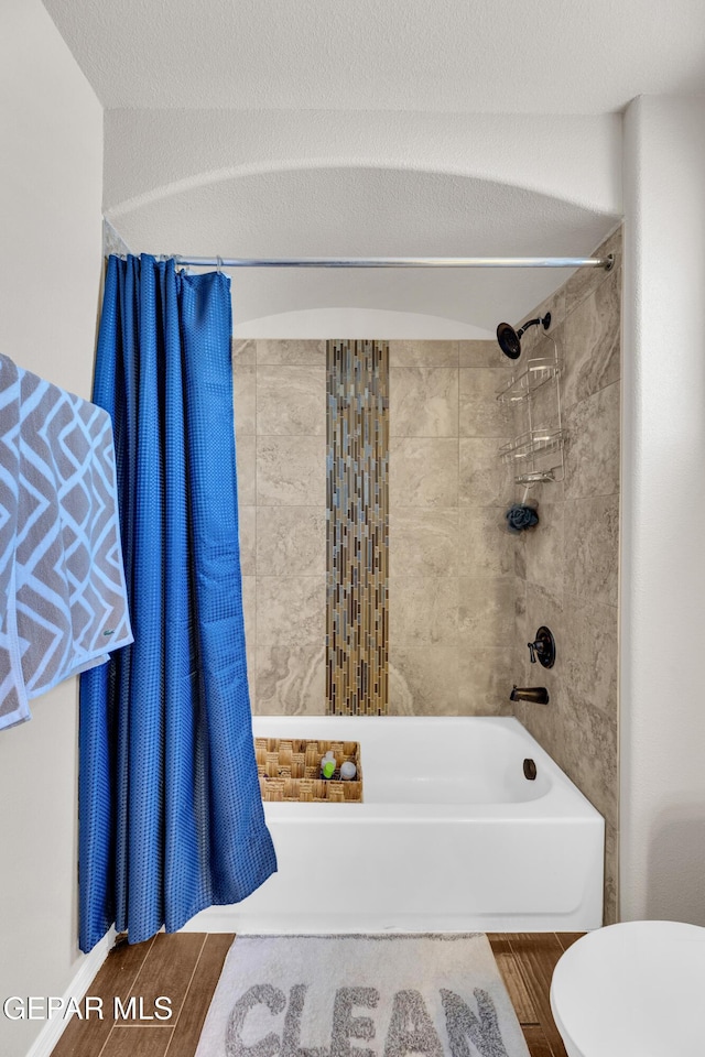 6716 Red Canyon Sage Ln, El Paso, TX 79912 - bathroom featuring wood finished floors, shower / bathtub combination, and toilet
