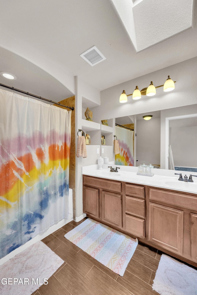 6716 Red Canyon Sage Ln, El Paso, TX 79912 - full bathroom featuring wood tiled floors and double vanity