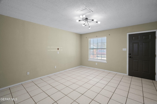 12008 Braveheart Ave, El Paso, TX 79936 - foyer entrance featuring a textured ceiling, a chandelier, and baseboards