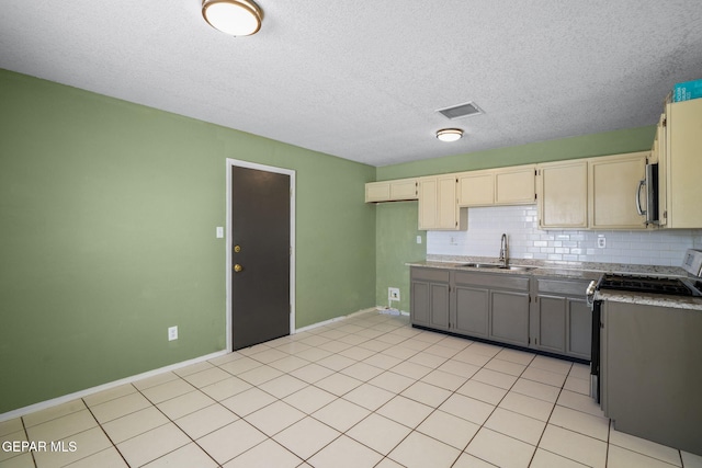 12008 Braveheart Ave, El Paso, TX 79936 - kitchen featuring a sink, appliances with stainless steel finishes, tasteful backsplash, baseboards, and a textured ceiling