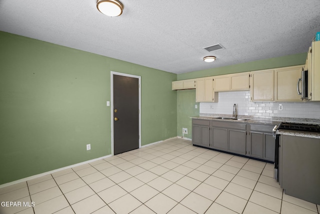 12008 Braveheart Ave, El Paso, TX 79936 - kitchen featuring a sink, stainless steel appliances, decorative backsplash, baseboards, and a textured ceiling
