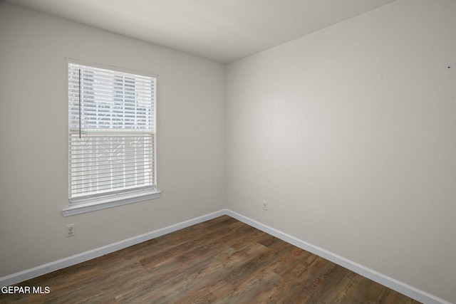 12008 Braveheart Ave, El Paso, TX 79936 - unfurnished room with baseboards and dark wood-type flooring