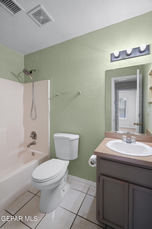 12008 Braveheart Ave, El Paso, TX 79936 - full bath featuring toilet, vanity, a textured ceiling, tile patterned floors, and washtub / shower combination