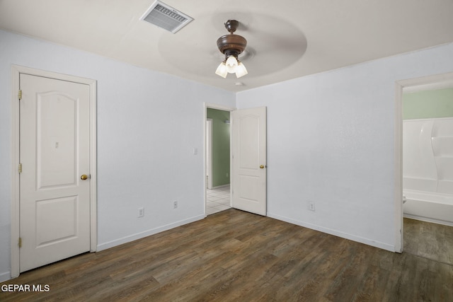 12008 Braveheart Ave, El Paso, TX 79936 - unfurnished bedroom with wood finished floors, baseboards, ensuite bath, and ceiling fan