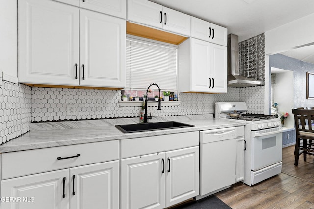 12119 Quail Harvest Ln, El Paso, TX 79936 - kitchen featuring white appliances, a sink, wall chimney range hood, white cabinets, and tasteful backsplash