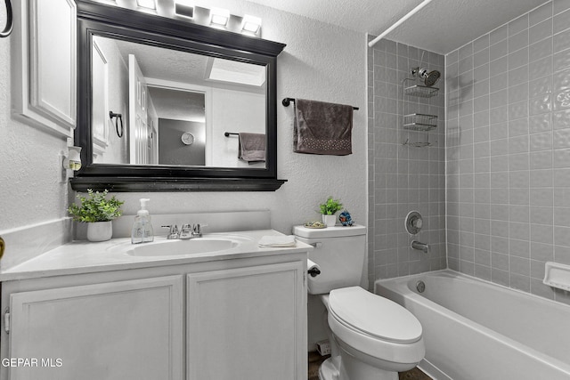 12119 Quail Harvest Ln, El Paso, TX 79936 - bathroom featuring a textured wall, toilet, vanity, a textured ceiling, and washtub / shower combination
