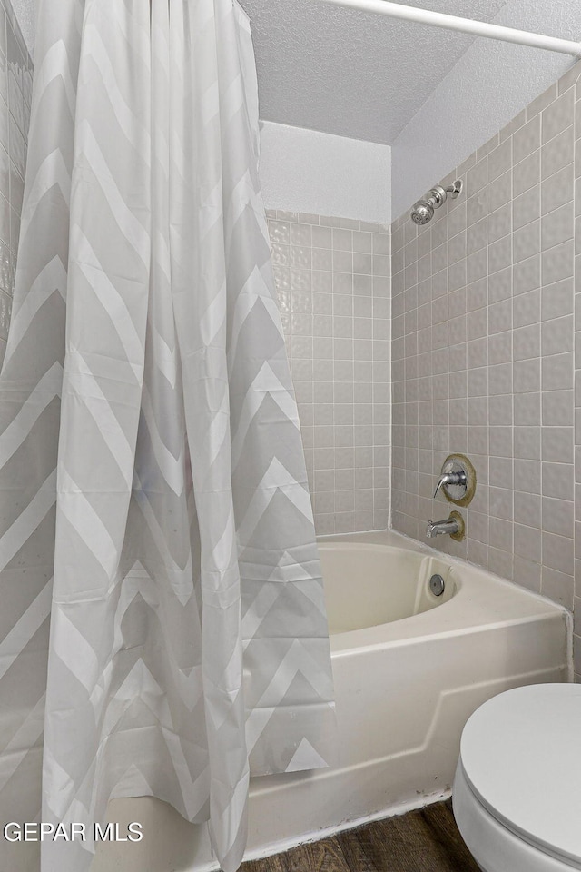 12119 Quail Harvest Ln, El Paso, TX 79936 - bathroom with shower / tub combo, toilet, and a textured ceiling