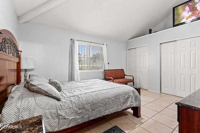 12119 Quail Harvest Ln, El Paso, TX 79936 - bedroom featuring lofted ceiling, two closets, and light tile patterned flooring