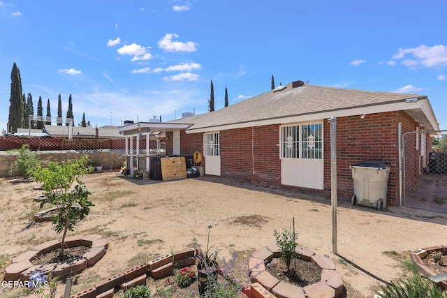 12119 Quail Harvest Ln, El Paso, TX 79936 - back of property with a fenced backyard, brick siding, a patio, and roof with shingles