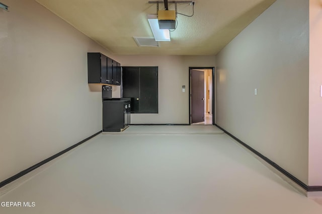 3303 Ward Robert Pl, El Paso, TX 79936 - garage featuring a garage door opener and baseboards
