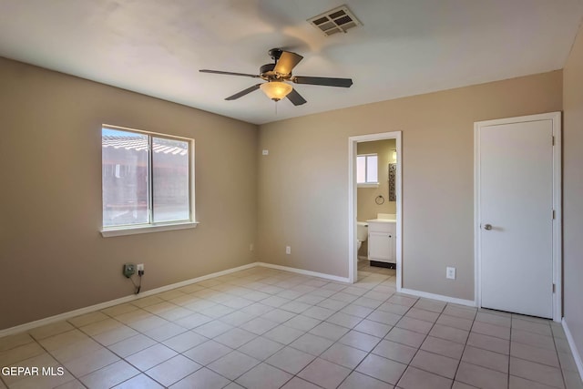 3303 Ward Robert Pl, El Paso, TX 79936 - unfurnished bedroom with light tile patterned floors, baseboards, a ceiling fan, and connected bathroom