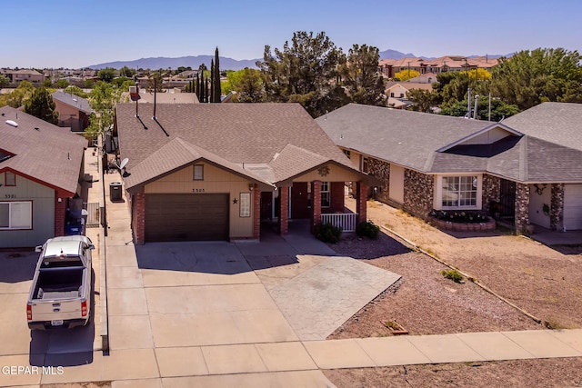 3303 Ward Robert Pl, El Paso, TX 79936 - view of front of home featuring a garage, a residential view, driveway, roof with shingles, and a mountain view