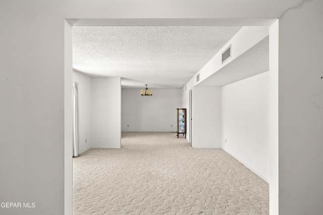 5445 Connors Ln, El Paso, TX 79932 - empty room featuring a chandelier, carpet flooring, and a textured ceiling