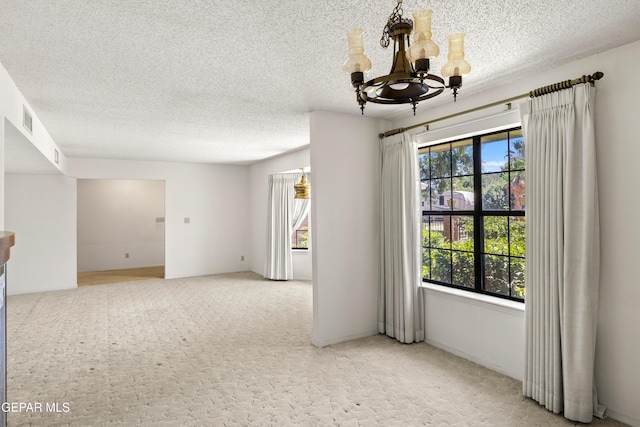 5445 Connors Ln, El Paso, TX 79932 - unfurnished room with a chandelier, a textured ceiling, and carpet