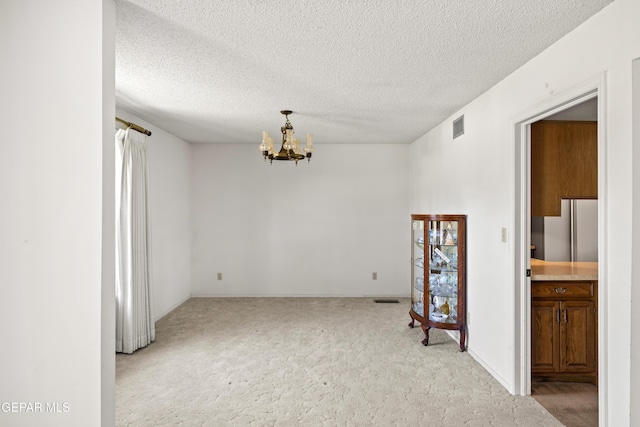 5445 Connors Ln, El Paso, TX 79932 - carpeted spare room featuring a chandelier and a textured ceiling