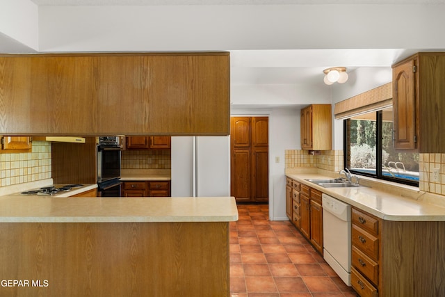 5445 Connors Ln, El Paso, TX 79932 - kitchen featuring white appliances, a sink, light countertops, and a peninsula