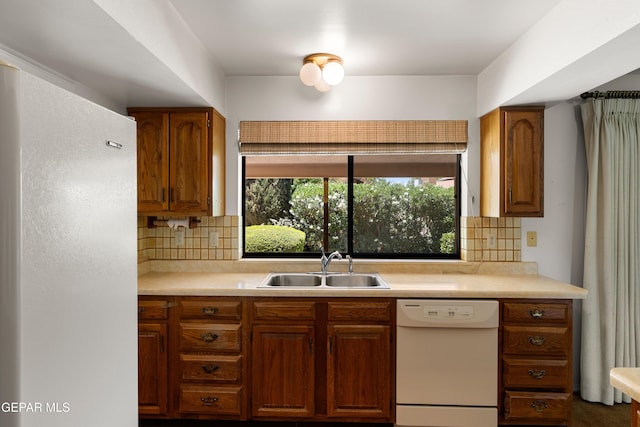 5445 Connors Ln, El Paso, TX 79932 - kitchen with white appliances, a sink, light countertops, decorative backsplash, and brown cabinets