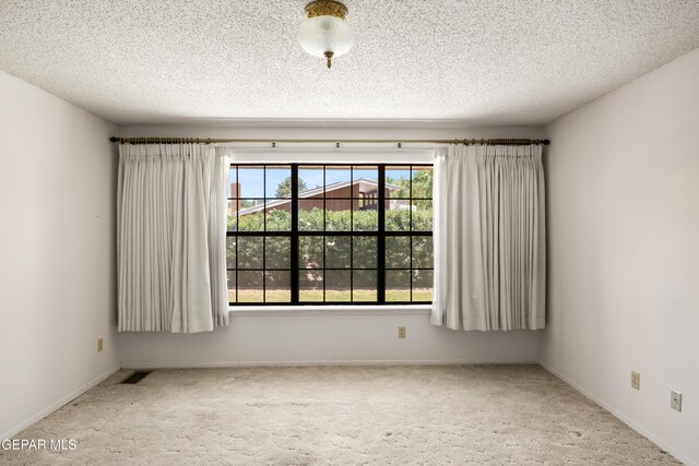 5445 Connors Ln, El Paso, TX 79932 - empty room with carpet, a textured ceiling, and baseboards