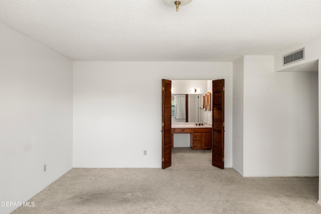 5445 Connors Ln, El Paso, TX 79932 - empty room featuring light colored carpet and a textured ceiling