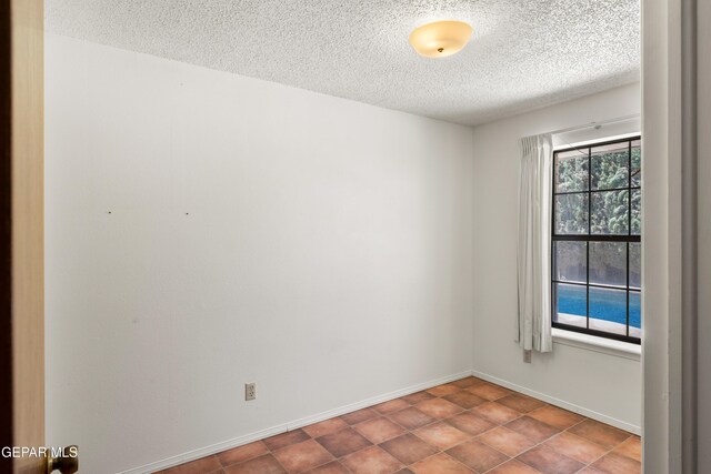 5445 Connors Ln, El Paso, TX 79932 - empty room featuring a textured ceiling and baseboards