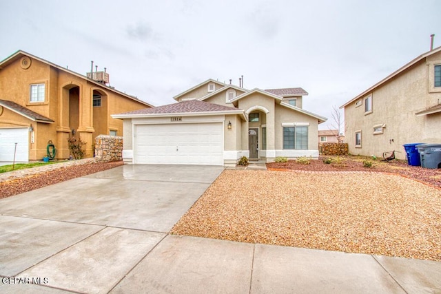 11924 Mesquite Rock Dr, El Paso, TX 79934 - view of front of house with driveway, an attached garage, and stucco siding