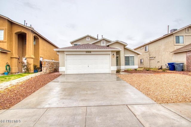 11924 Mesquite Rock Dr, El Paso, TX 79934 - view of front of home featuring driveway, an attached garage, stucco siding, and roof with shingles