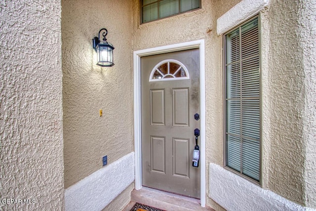 11924 Mesquite Rock Dr, El Paso, TX 79934 - doorway to property with stucco siding