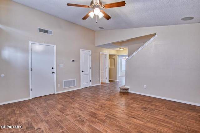 11924 Mesquite Rock Dr, El Paso, TX 79934 - unfurnished living room with ceiling fan, wood finished floors, baseboards, high vaulted ceiling, and a textured ceiling