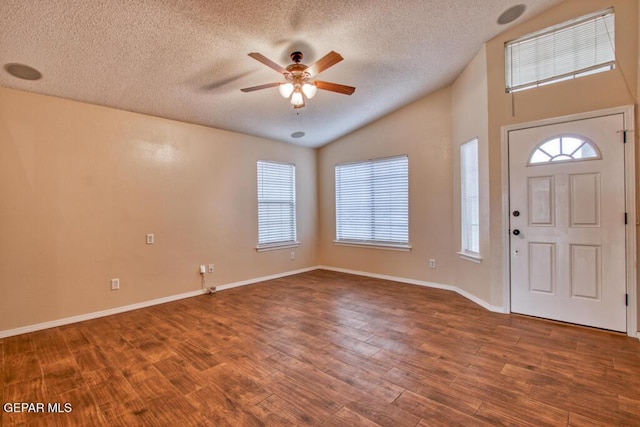 11924 Mesquite Rock Dr, El Paso, TX 79934 - entryway with ceiling fan, a textured ceiling, vaulted ceiling, wood finished floors, and healthy amount of natural light