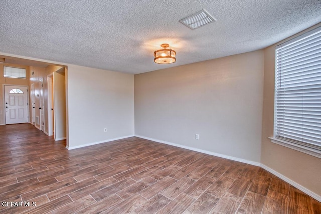 11924 Mesquite Rock Dr, El Paso, TX 79934 - spare room featuring a textured ceiling, wood finished floors, and baseboards