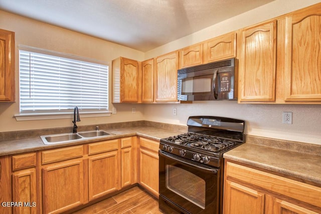 11924 Mesquite Rock Dr, El Paso, TX 79934 - kitchen featuring black appliances, a sink, wood finished floors, and light brown cabinets