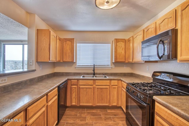 11924 Mesquite Rock Dr, El Paso, TX 79934 - kitchen featuring black appliances, a sink, a textured ceiling, and dark countertops