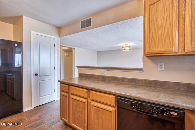 11924 Mesquite Rock Dr, El Paso, TX 79934 - kitchen with black dishwasher, dark countertops, dark wood finished floors, baseboards, and a textured ceiling