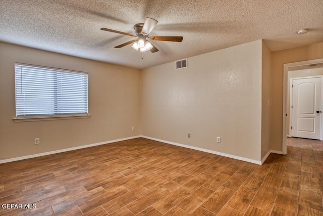11924 Mesquite Rock Dr, El Paso, TX 79934 - spare room with a ceiling fan, wood finished floors, a textured ceiling, and baseboards