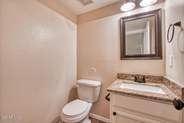 11924 Mesquite Rock Dr, El Paso, TX 79934 - bathroom featuring toilet, vanity, and a textured wall