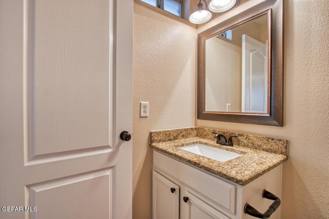 11924 Mesquite Rock Dr, El Paso, TX 79934 - bathroom featuring a textured wall and vanity