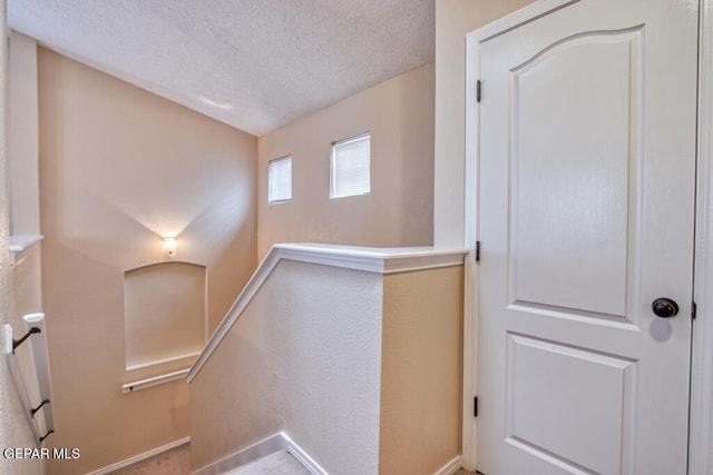 11924 Mesquite Rock Dr, El Paso, TX 79934 - stairway featuring a textured ceiling, baseboards, and a textured wall