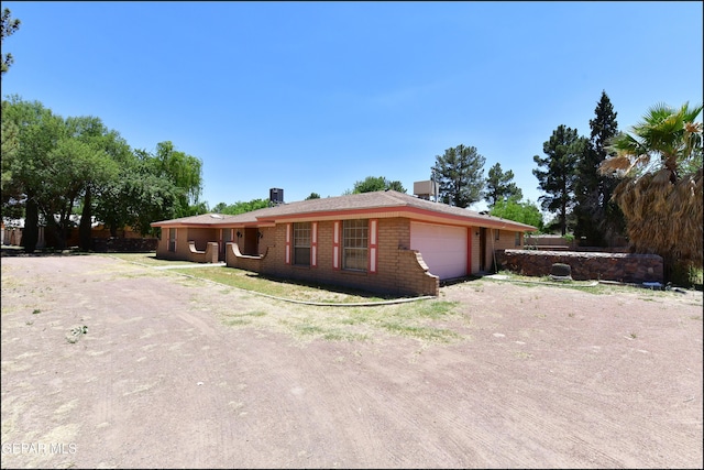 312 Caporal Ct, El Paso, TX 79932 - single story home with a garage, brick siding, and driveway