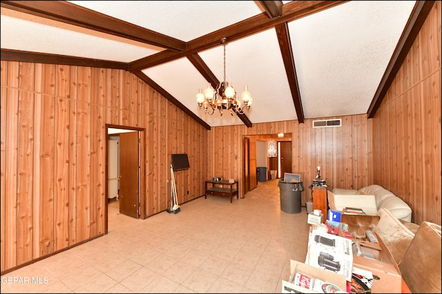 312 Caporal Ct, El Paso, TX 79932 - living room with a chandelier, wood walls, a textured ceiling, and light floors
