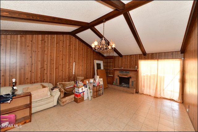 312 Caporal Ct, El Paso, TX 79932 - living area with wood walls, a chandelier, a fireplace, light tile patterned floors, and a textured ceiling