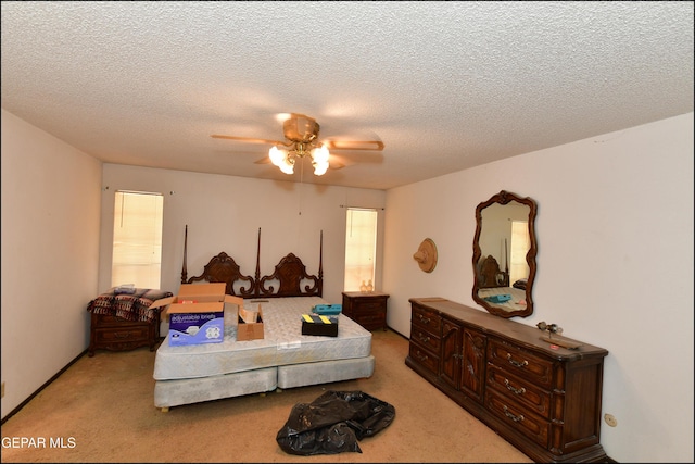 312 Caporal Ct, El Paso, TX 79932 - bedroom with light colored carpet, a textured ceiling, and ceiling fan