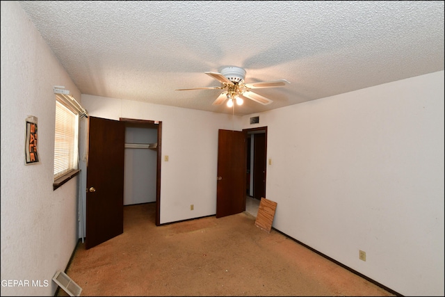 312 Caporal Ct, El Paso, TX 79932 - unfurnished bedroom with light colored carpet, a closet, a spacious closet, ceiling fan, and a textured ceiling