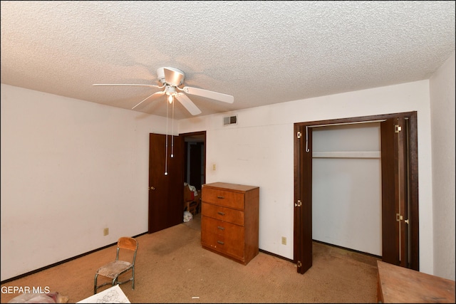 312 Caporal Ct, El Paso, TX 79932 - unfurnished bedroom with light colored carpet, a closet, a textured ceiling, and a ceiling fan
